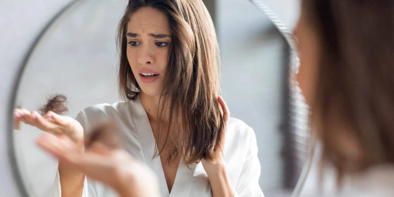 woman hair loss mirror distress