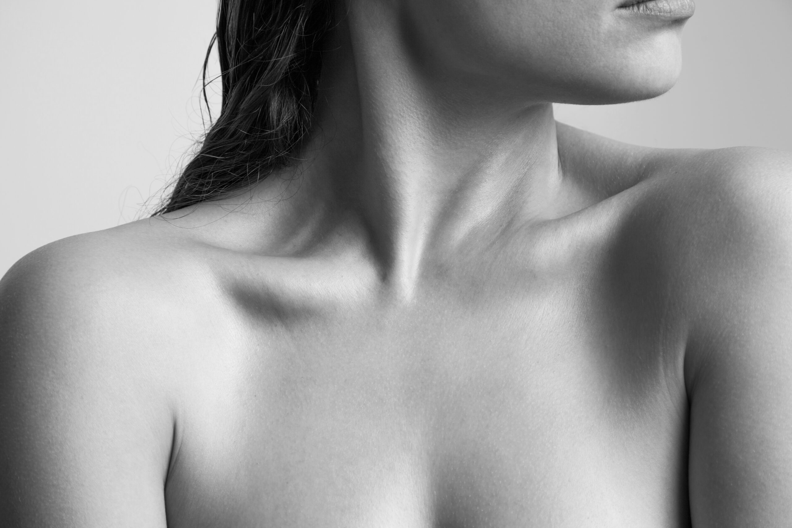 close up of woman neck and shoulders natural beauty skin bw