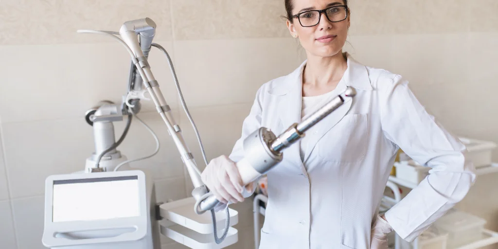 female doctor holds in her hands a carbon dioxide laser female doctor holds in her hands a carbon dioxide laser